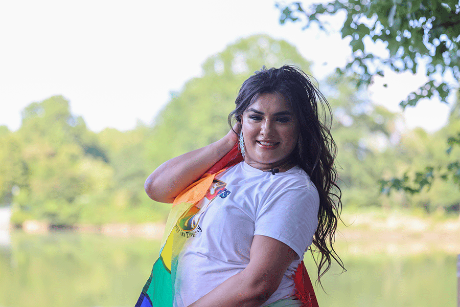 Aubri Escalera posing with an LGBTQIA+ flag